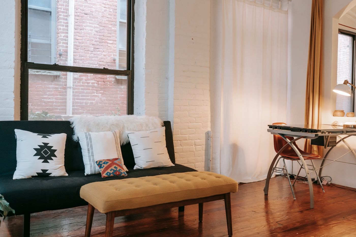 Sash windows beside a sofa in a bright living room